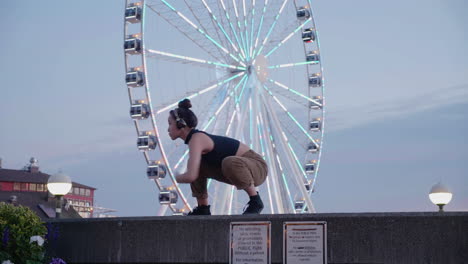 young, female, contemporary dancer near an urban ferris wheel