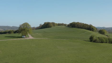 drone - aerial panorama shot of al lonely chapel on a field with grass and a road with panorama of the seven mountains - siebengebirge 25p