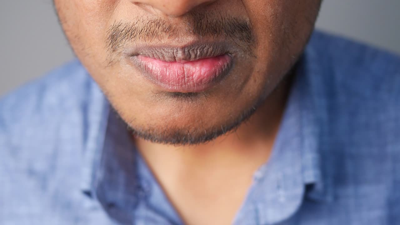 Close-up of a man's mouth with dry or discolored lips