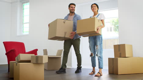 pareja llevando cajas a la nueva casa el día de la mudanza