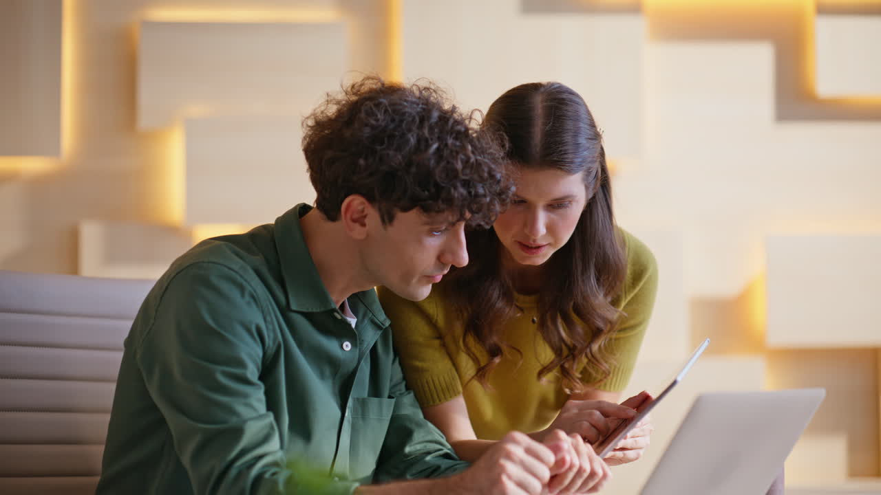 Two coworkers collaborating in the office