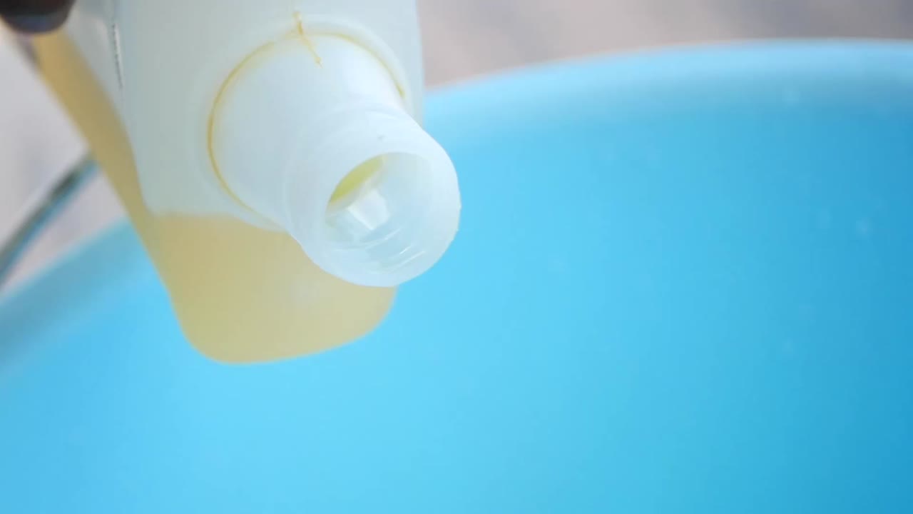 Pouring liquid into a blue container