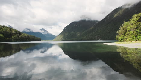 reflections of majestic mountains on the serene surface of a new zealand lake