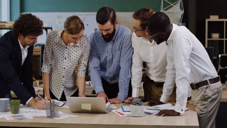 multiethnic business team analyzing documents, charts, financial reports and graphics in the office