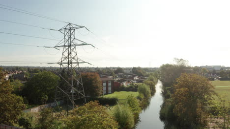 descending aerial shot of suburban electricity pylon