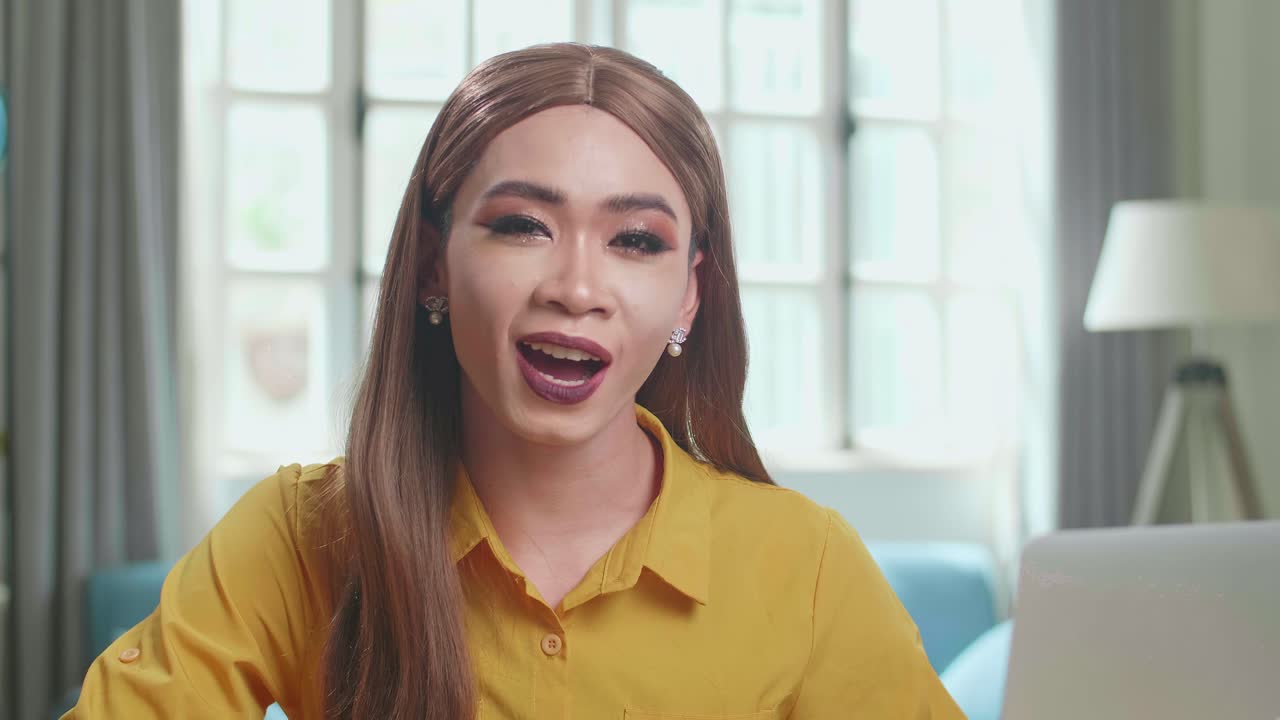 Influencer Young Transgender Woman Blogger Read Comment On Laptop Computer. Vlogger Tells How To Be Beautiful In Home Studio
