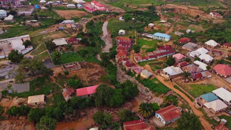 beautiful aerial of a dry river running through the town of kurudu nyanya, nigeria