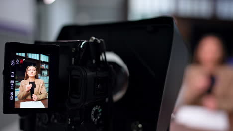 professional female blogger on the camera display. close up. blogger and influencer filming video. blurred backdrop.