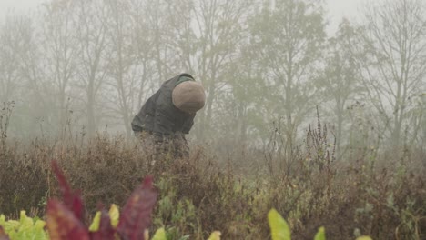 Environmental-Portrait-Of-A-Vegetable-Farmer,-Talking-On-Phone-During-Harvest