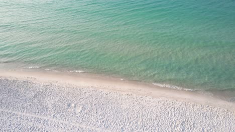 Flyover-white-sand-dunes-on-a-sunny-day-on-the-Gulf-of-Mexico-with-emerald-waters