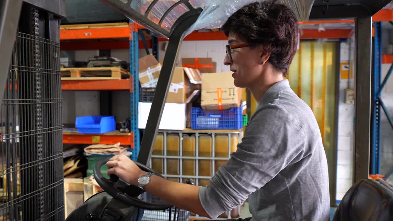 Woman Operating Forklift in Warehouse