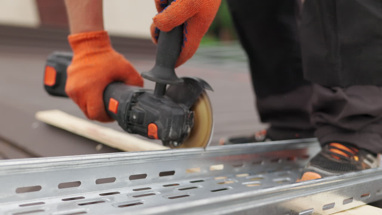 Construction worker using a grinder to cut metal conduit