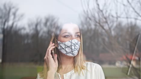 businesswoman communicating over a cell phone during corona virus lockdown