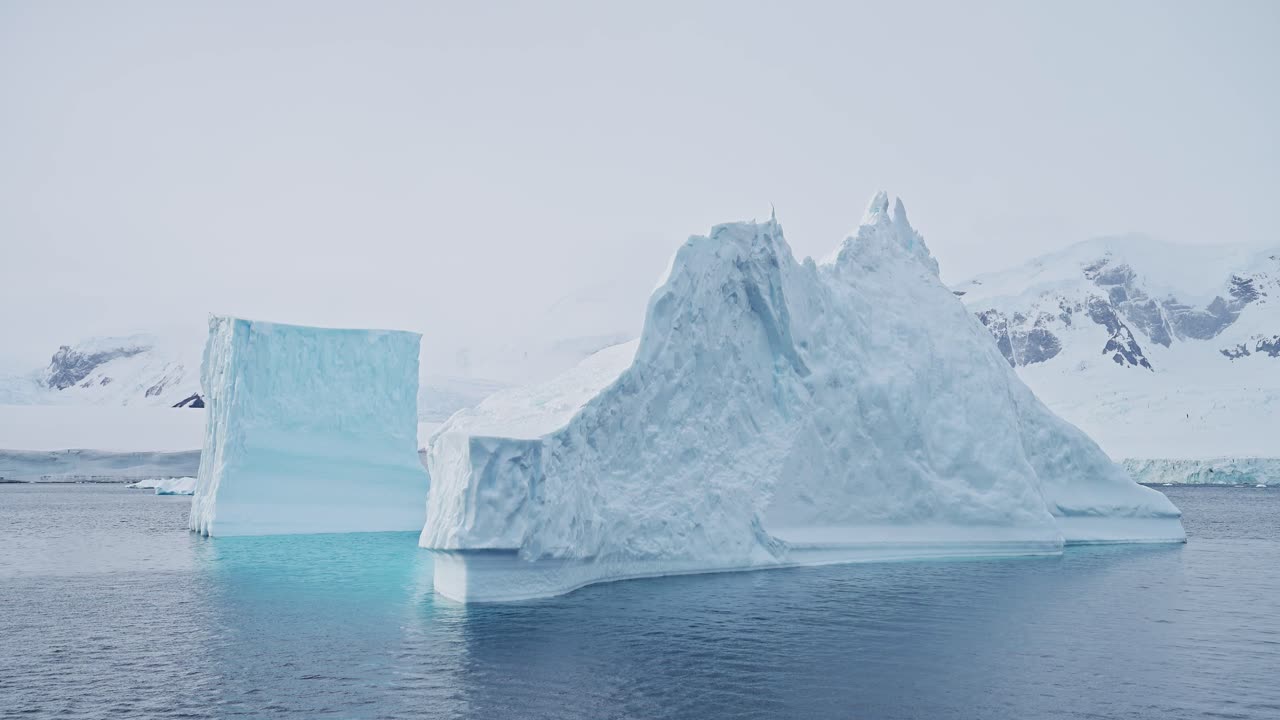 Big Large Iceberg Ice Formations in Sea, Floating in Antarctica Ocean Sea Water in Beautiful Antarctic Peninsula Winter Scenery, Amazing Nature in Coastal Coast Scene of Massive Enormous Huge Icebergs