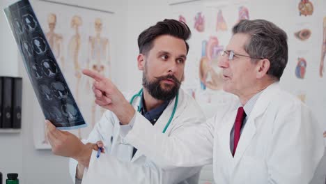 handheld view of two busy doctors discussing some medical records