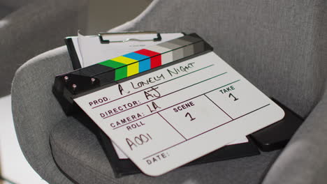 close up of film clapperboard or slate with production details shooting movie or video in studio