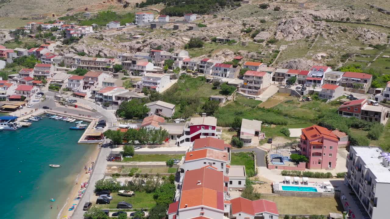 Town of Metajna marina in the island of Otok Pag in Croatia with beach condos, Aerial flyover view