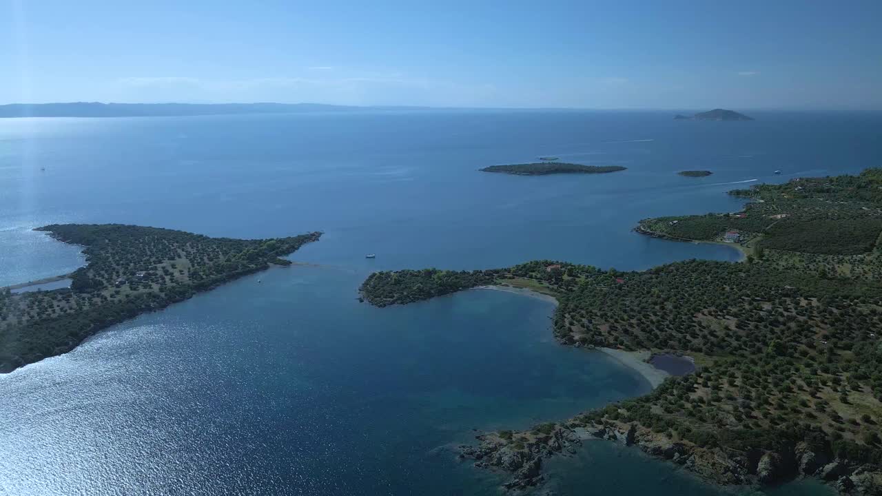 Cinematic rotating up high 4K drone clip over the tropical blue waters of Toroni in Chalkidiki