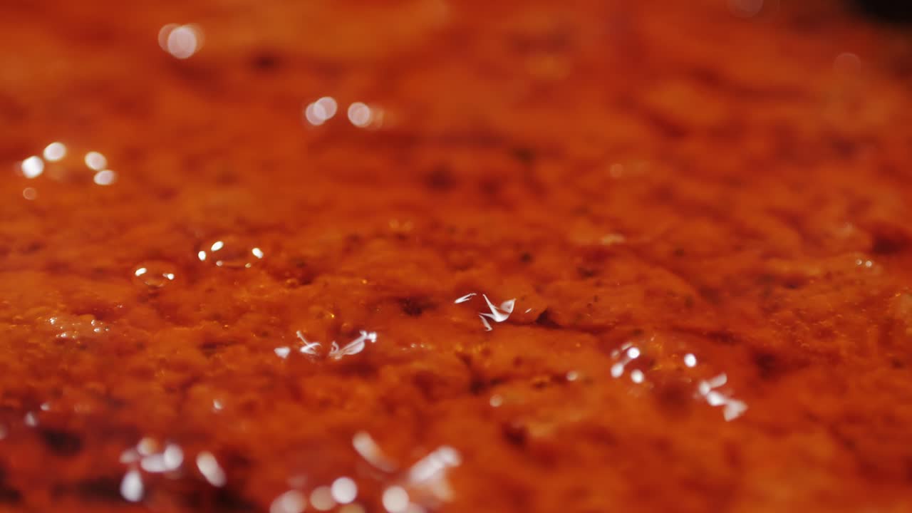 Cooking tomato sauce close-up. Classic homemade Italian tomato sauce for pasta and pizza in the pan. Chef cooking traditional Italian food. High quality 4k footage