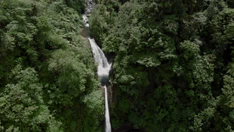 la paz waterfall surrounded by green forest under the sunny day in la paz waterfall gardens nature park, alajuela, costa rica.-  aerial shot
