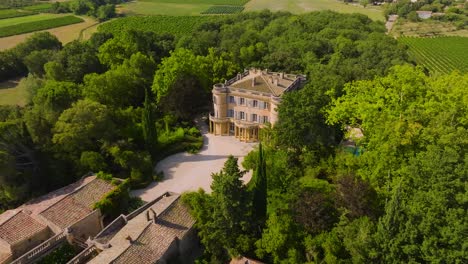 Aerial-revealing-shot-of-the-large-grounds-at-Chateau-de-Castille-in-the-Uzes-countryside