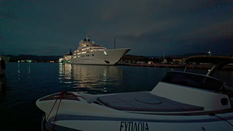 luxury german built super yacht illuminated in greek harbour at night