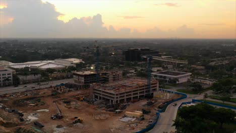 an aerial timelapse of a construction site during a golden sunrise in florida