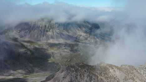 A-drone-shot-of-people-on-a-peak-in-the-Scottish-highlands