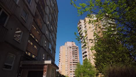 concrete apartment blocks of varying high-rise shapes under a clear sunny spring sky