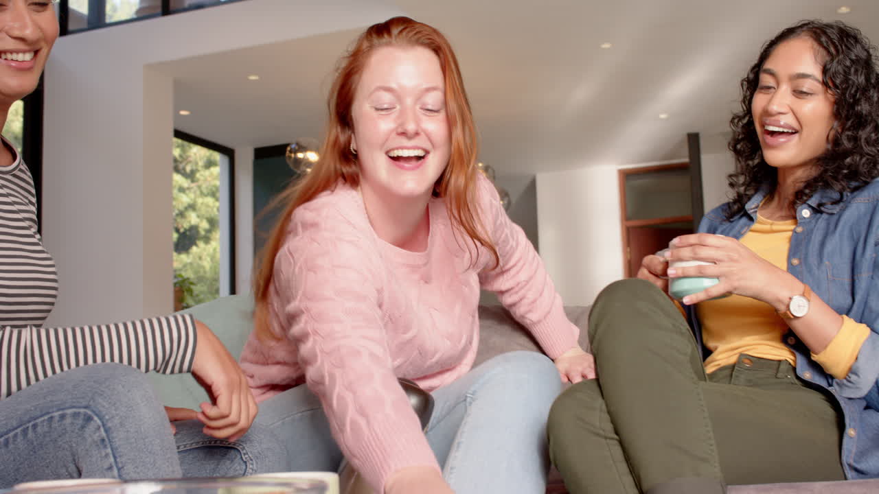 Laughing and showing smartphone, woman with prosthetic leg enjoying with female friends
