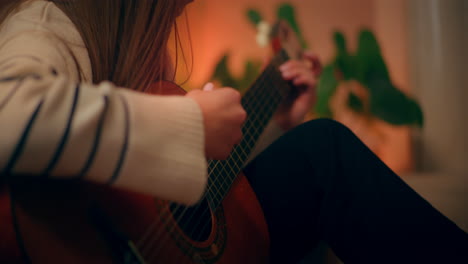 woman playing guitar writing song composing music