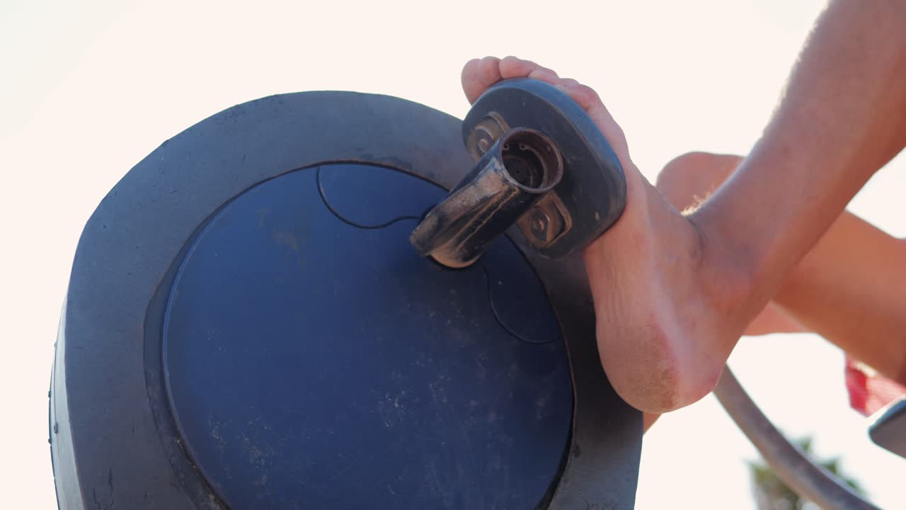 Person Exercising on Outdoor Pedal Machine
