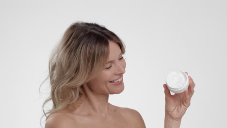 woman holding facial cream