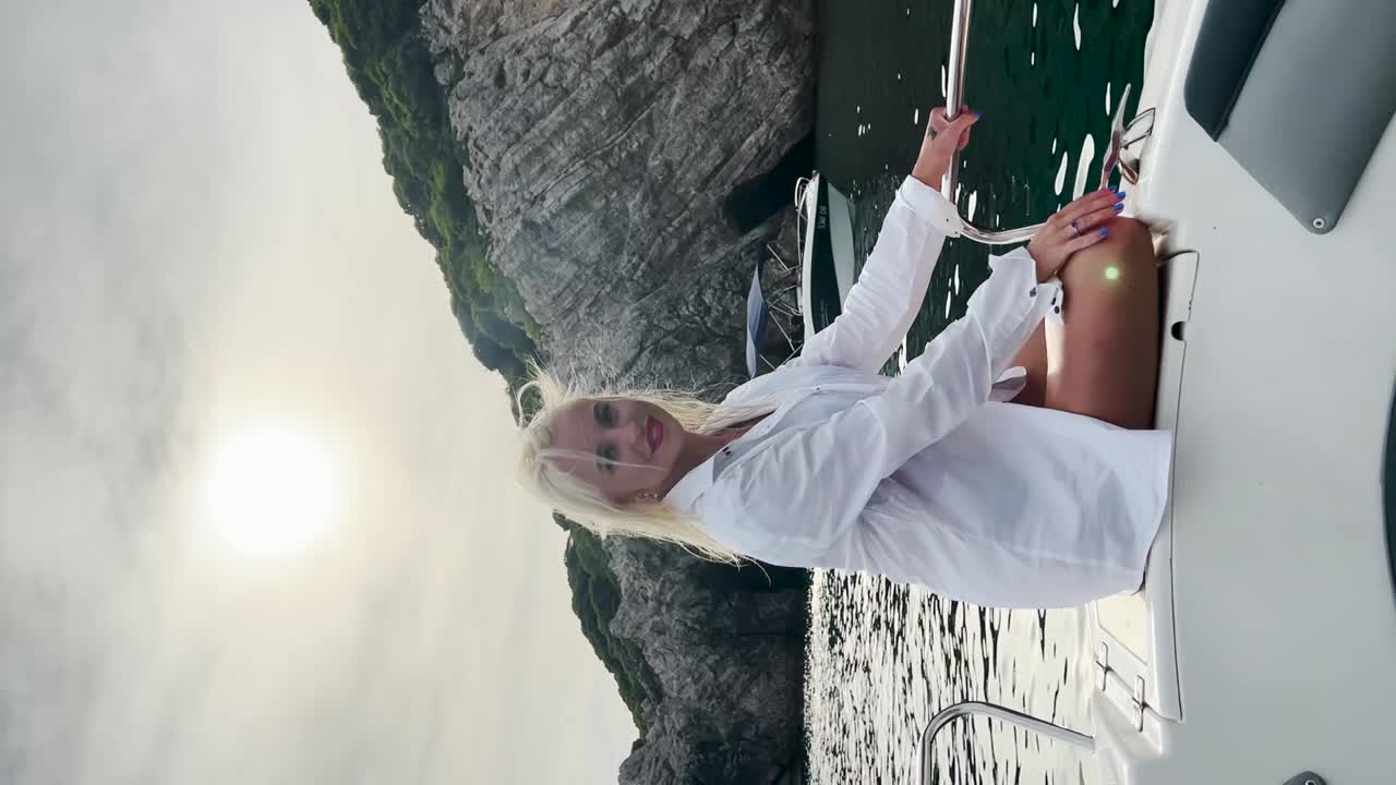 Young woman sitting on a boat deck enjoying the view of the sea, Croatia