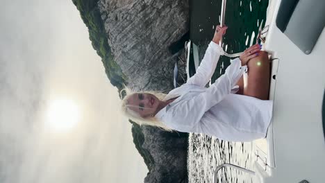 young woman sitting on a boat deck enjoying the view of the sea, croatia