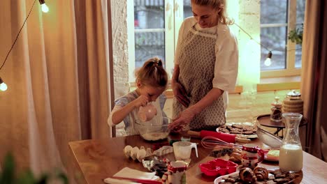 mother and daughter baking christmas cookies