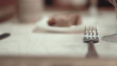 waiter at the restaurant sets the table close-up slow motion