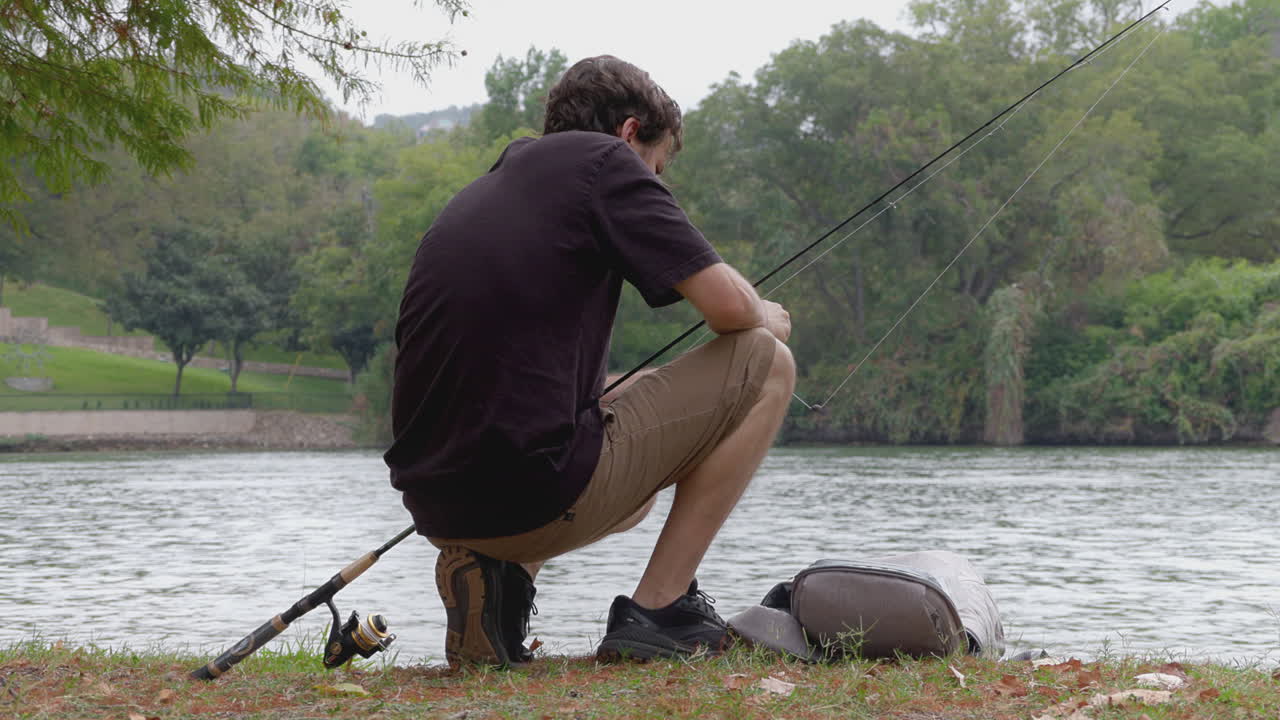 Man Fishing by the River Bank