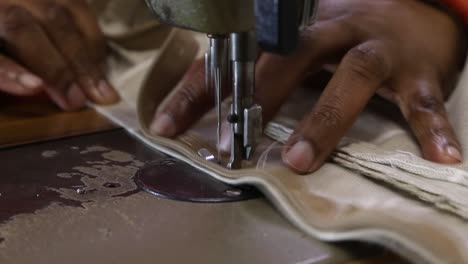 clip of zip being sewn into cushion with electric sewing machine