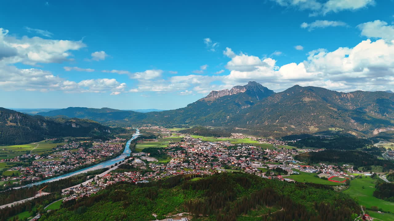 Cozy residential area in the picturesque valley among the stunning mountains. Aerial perspective on the Plansee Lake in Reutte District, Tyrol, Austria.