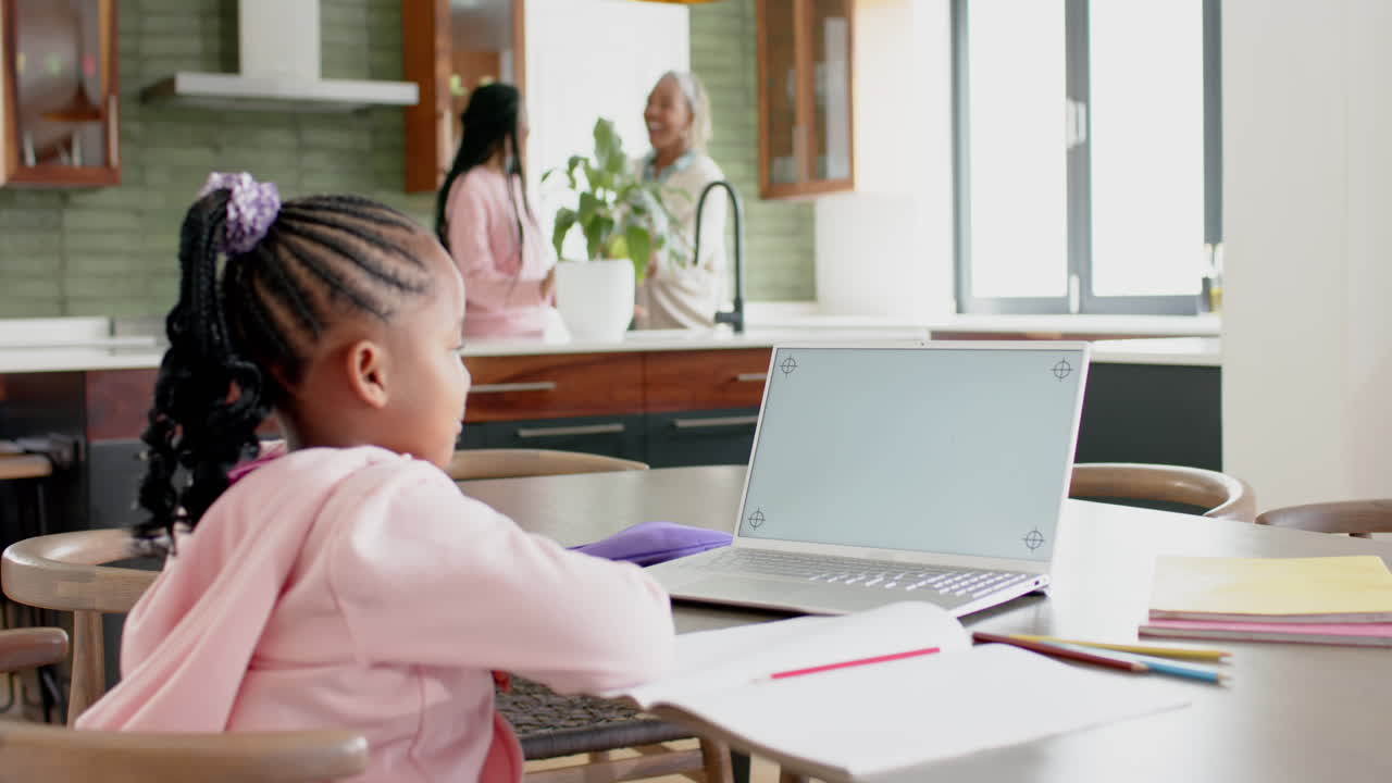 African american girl having online class using laptop with copy space, slow motion