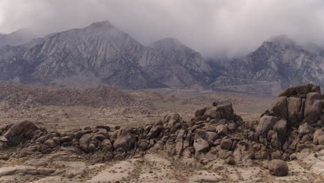 aerial drone dolly around the alabama hills of california's sierra nevada mountain range while clouds gather