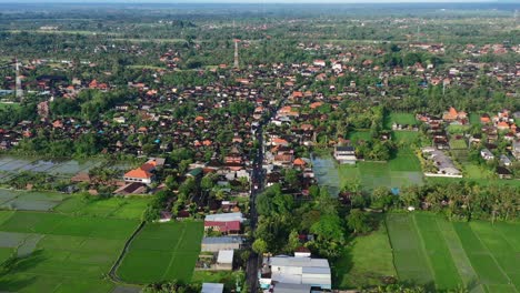 Aerial-skyline-of-highway-road-surrounded-by-rice-fields-in-Ubud-Bali-at-sunrise