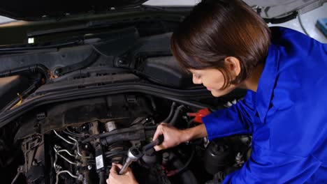 Female-mechanic-servicing-a-car