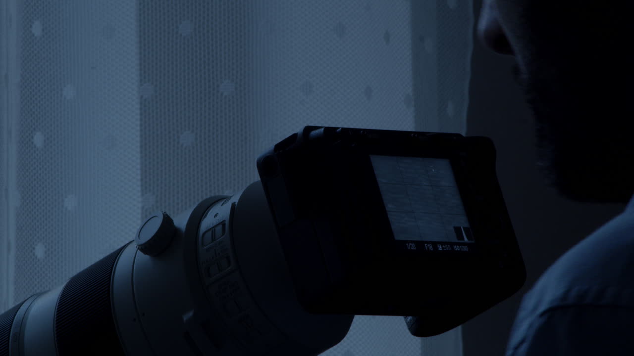 detective detrás de una cortina en una habitación oscura, captura fotos de un sospechoso en la calle, disparo de cerca