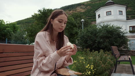 woman eating sandwich in park