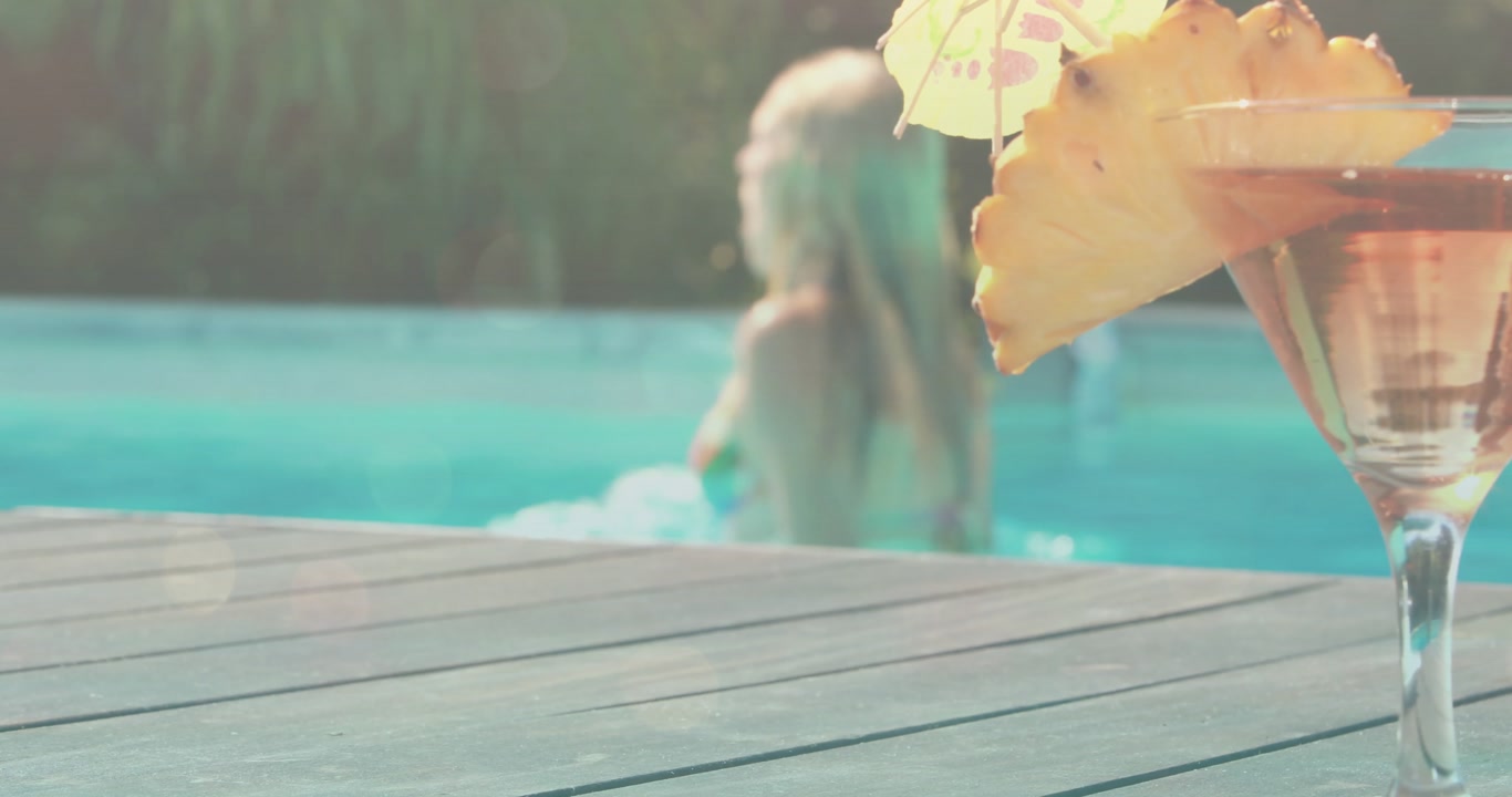 Woman exiting pool upon reaching deck for health break, with animated flares highlighting cocktail