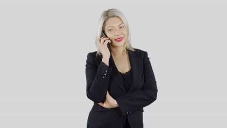 an attractive happy blonde haired businesswoman is on her mobile cell phone talking and listening