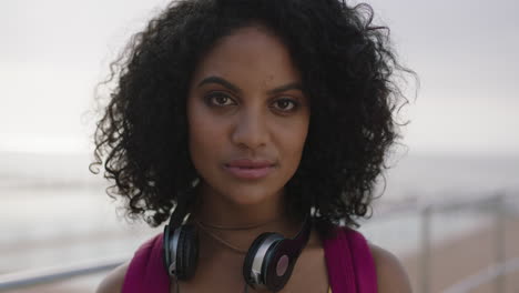 close-up-portrait-of-confident-mixed-race-woman-with-afro-removes-sunglasses-smiling-alluring-flirty