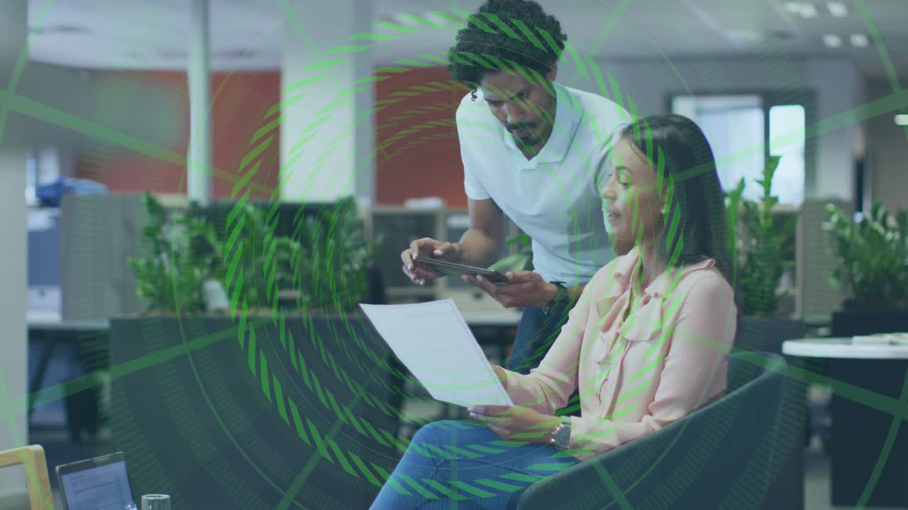 Woman scanning report, man leaning with phone, updating green charts discussing business analytics